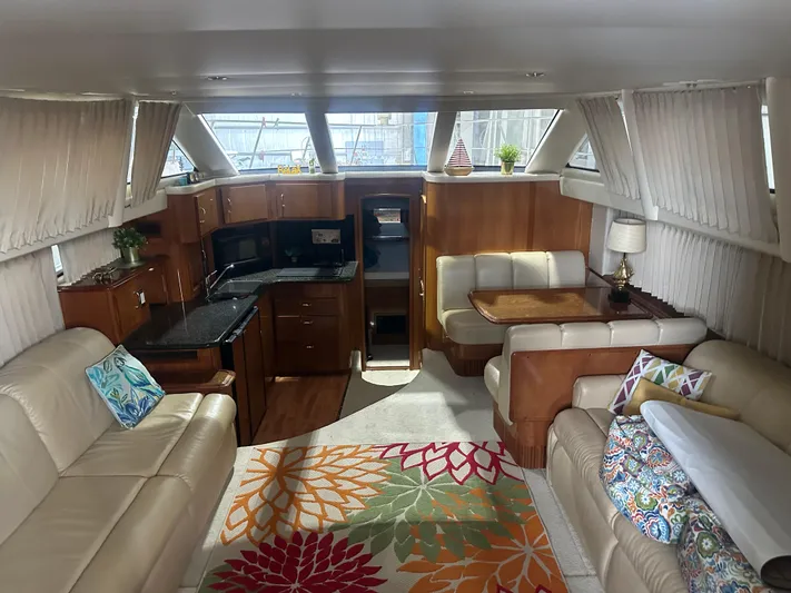  Yacht Photos Pics Luxurious 2005 Carver 44 CMY yacht interior with elegant seating, vibrant rug, and modern kitchen.