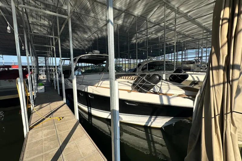  Yacht Photos Pics 2006 Four Winns 378 Vista yacht docked in a covered marina.