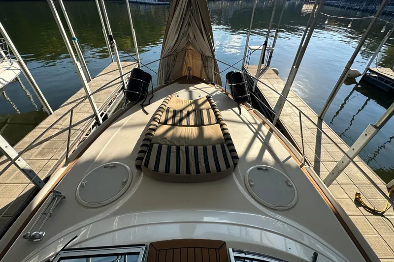  Yacht Photos Pics 2006 Four Winns 378 Vista yacht docked, featuring a spacious sun deck with striped cushions.