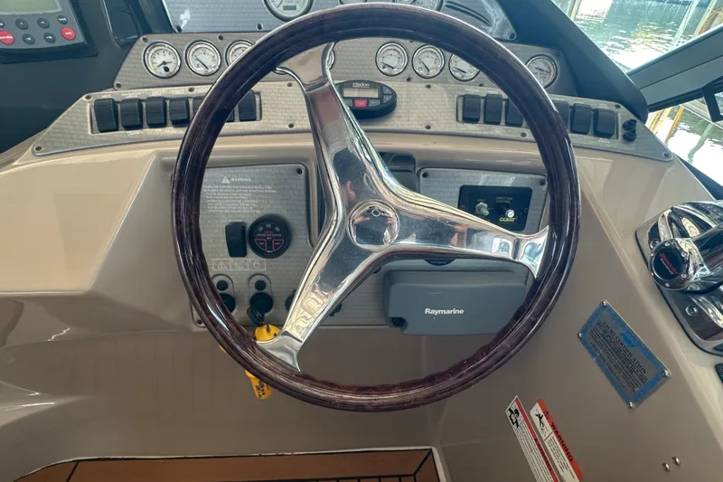  Yacht Photos Pics Steering wheel and dashboard of 2006 Four Winns 378 Vista boat, featuring gauges and controls.