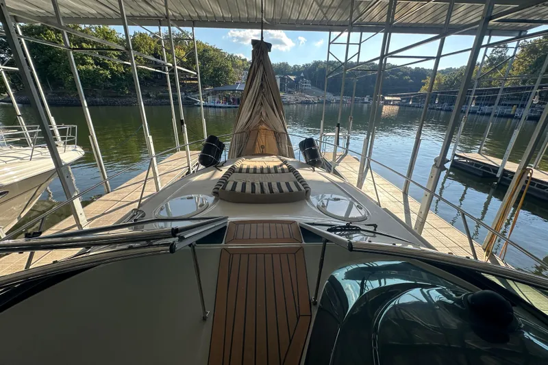  Yacht Photos Pics 2006 Four Winns 378 Vista yacht docked in a marina, surrounded by calm water.