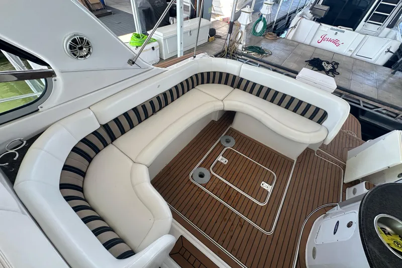  Yacht Photos Pics 2006 Four Winns 378 Vista yacht interior with curved seating and teak flooring.