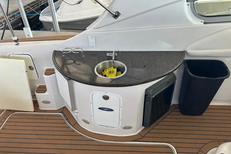  Yacht Photos Pics 2006 Four Winns 378 Vista yacht kitchenette with sink, countertop, and trash bin.