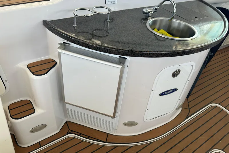  Yacht Photos Pics 2006 Four Winns 378 Vista yacht kitchenette with sink, countertop, and mini fridge.