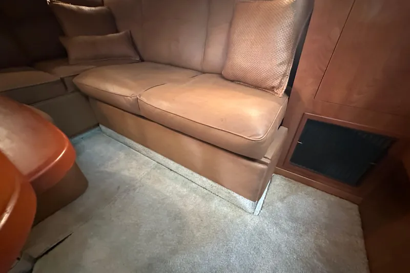  Yacht Photos Pics 2006 Four Winns 378 Vista interior with brown leather seating and wooden cabinetry.