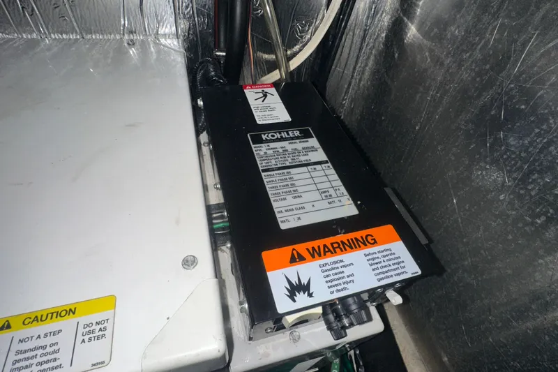  Yacht Photos Pics Engine compartment of 2006 Four Winns 378 Vista with Kohler generator and warning labels.