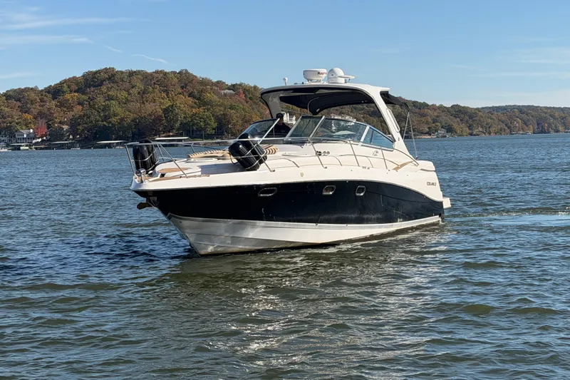  Yacht Photos Pics 2006 Four Winns 378 Vista boat cruising on a scenic lake with autumn foliage.