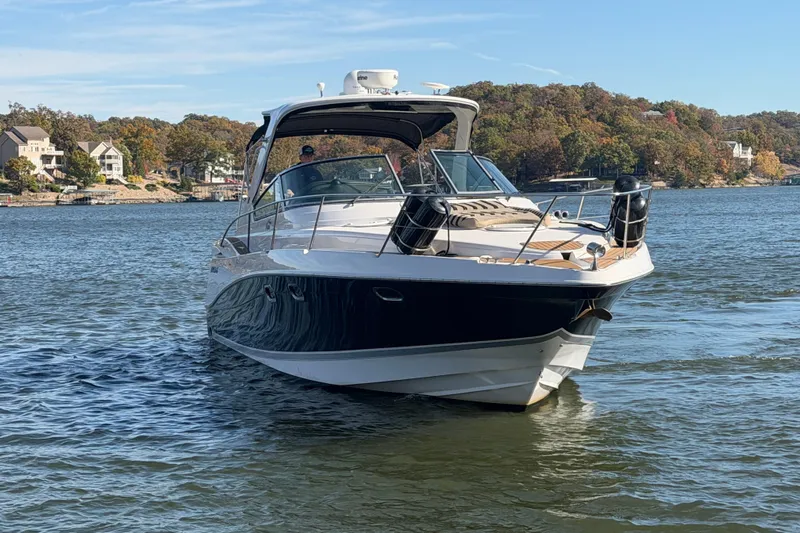  Yacht Photos Pics 2006 Four Winns 378 Vista boat cruising on a scenic lake with autumn foliage.
