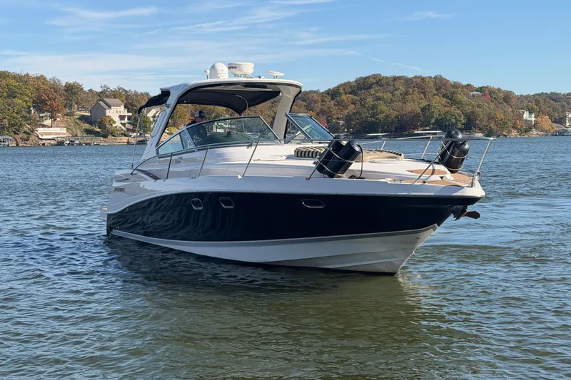  Yacht Photos Pics 2006 Four Winns 378 Vista boat on a scenic lake with wooded shoreline.