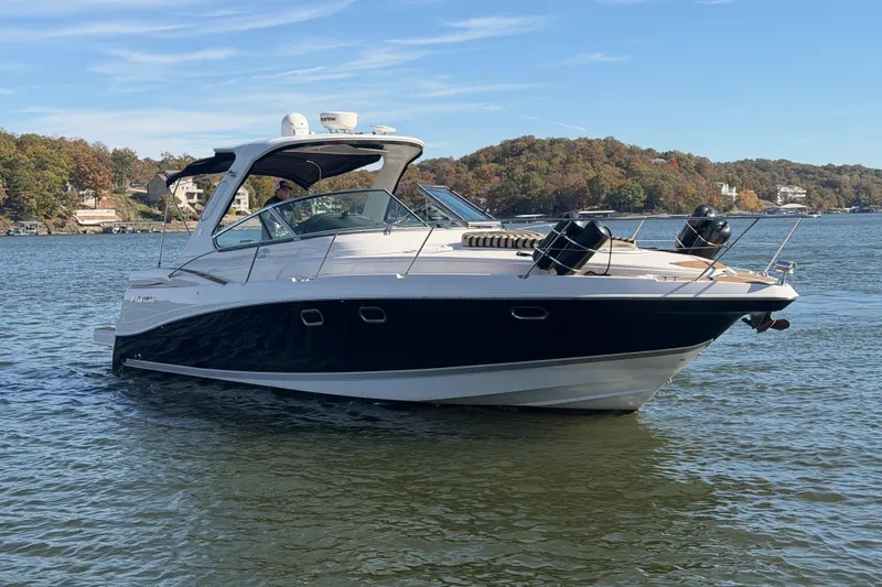  Yacht Photos Pics 2006 Four Winns 378 Vista boat cruising on a scenic lake with wooded shoreline.