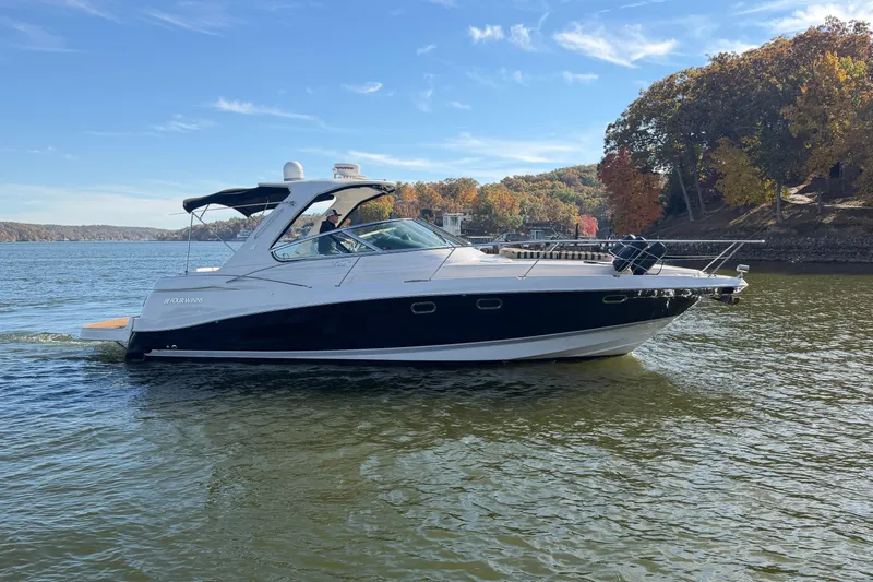  Yacht Photos Pics 2006 Four Winns 378 Vista boat cruising on a scenic lake with autumn foliage.