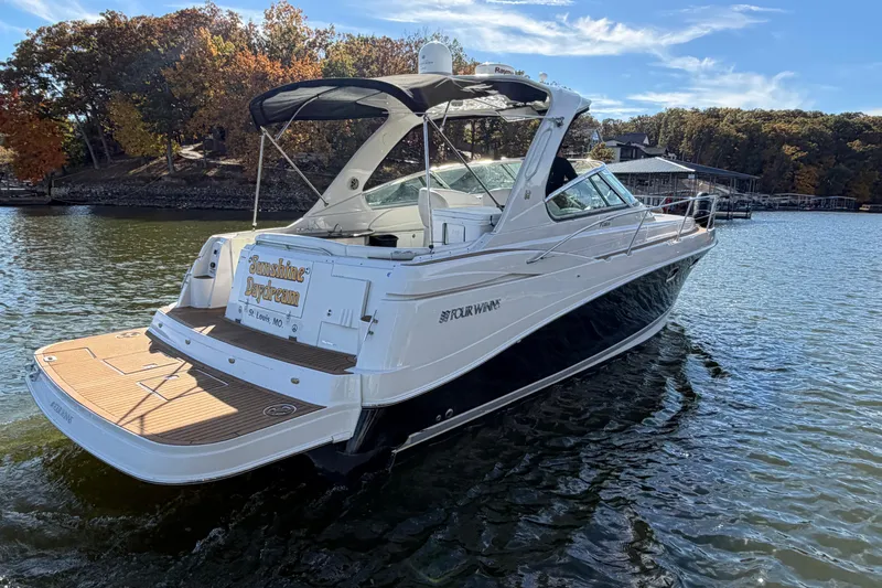  Yacht Photos Pics 2006 Four Winns 378 Vista boat on a lake with autumn trees in the background.