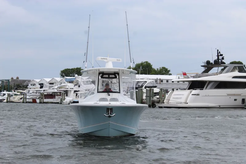 Dojo Yacht Photos Pics 2020 Regulator 28 boat docked in a marina with other yachts.