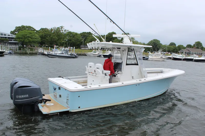Dojo Yacht Photos Pics 2020 Regulator 28 boat with Yamaha engine on a calm waterway.