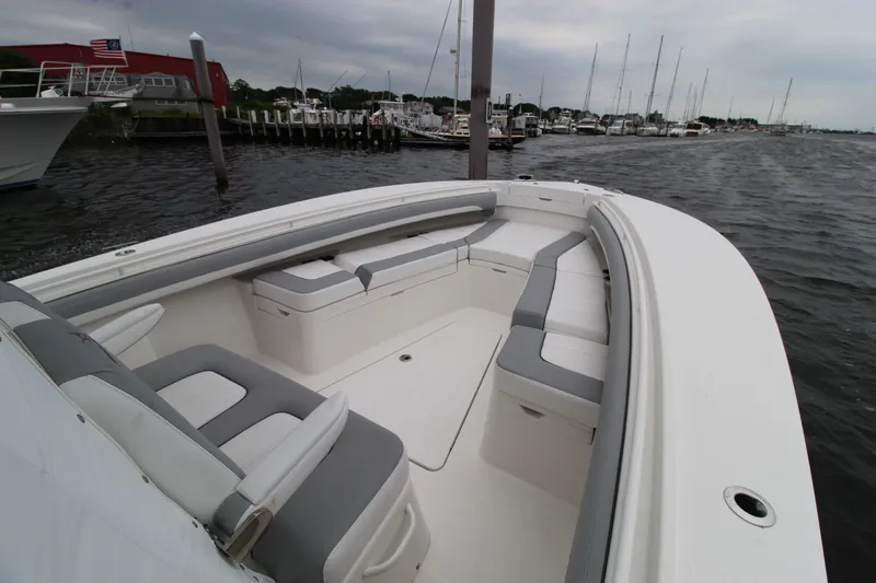 Dojo Yacht Photos Pics 2020 Regulator 28 boat with spacious seating, docked at a marina.