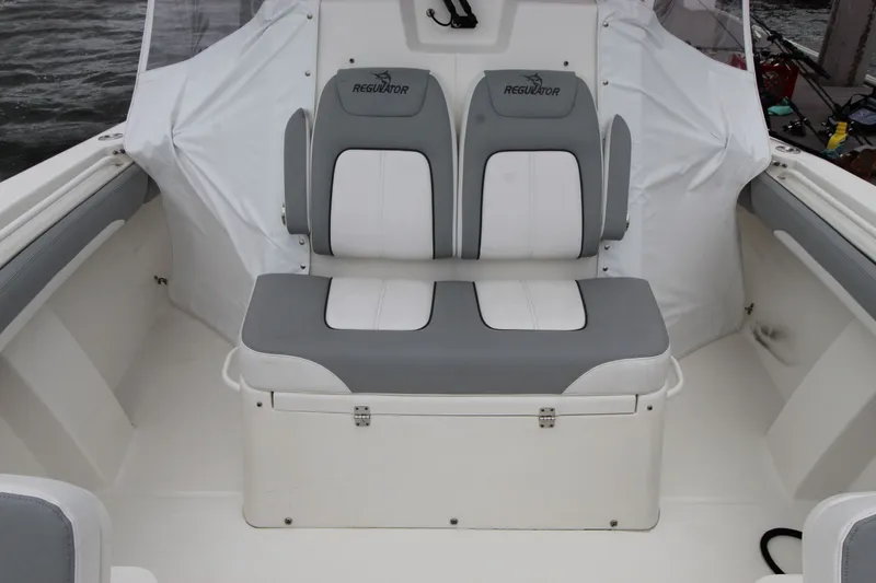 Dojo Yacht Photos Pics 2020 Regulator 28 boat seating area with gray and white cushioned seats.
