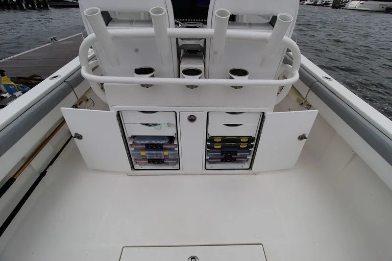 Dojo Yacht Photos Pics 2020 Regulator 28 boat with open storage compartments and rod holders on deck.