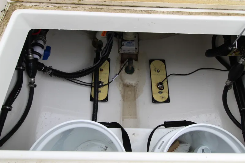 Dojo Yacht Photos Pics Interior view of a 2020 Regulator 28 boat's storage compartment with wiring and plumbing.