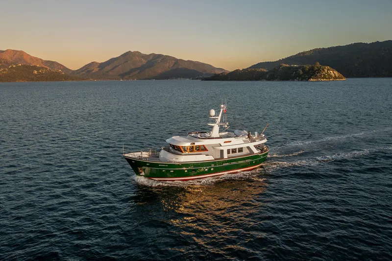 Yosma Yacht Photos Pics Motor Yacht 71' cruising on serene waters at sunset, 2013 model.