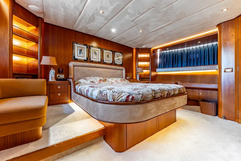 Yosma Yacht Photos Pics Luxurious 2013 Motor Yacht bedroom with elegant wood paneling and ambient lighting.