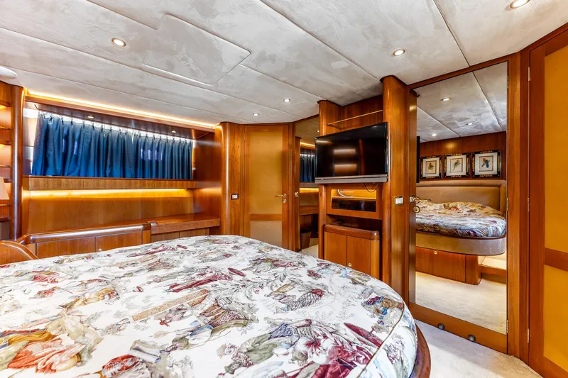 Yosma Yacht Photos Pics Luxurious 2013 Motor Yacht 71' bedroom with elegant wood finishes and modern amenities.