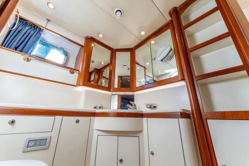 Yosma Yacht Photos Pics Luxurious bathroom interior of a 2013 71' motor yacht with wood accents and mirrors.