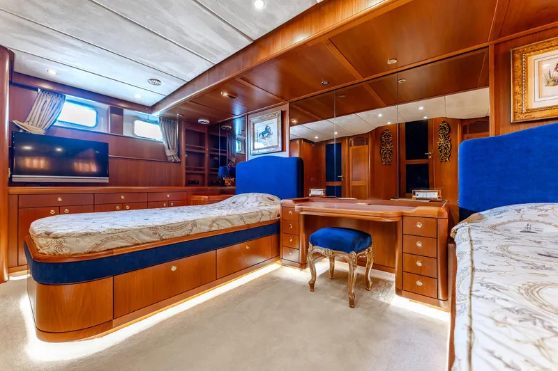 Yosma Yacht Photos Pics Luxurious 2013 Motor Yacht interior with elegant wood finish and plush blue accents.