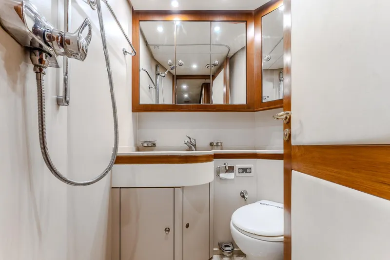 Yosma Yacht Photos Pics Luxurious bathroom in a 2013 71' motor yacht, featuring modern fixtures and elegant wood accents.