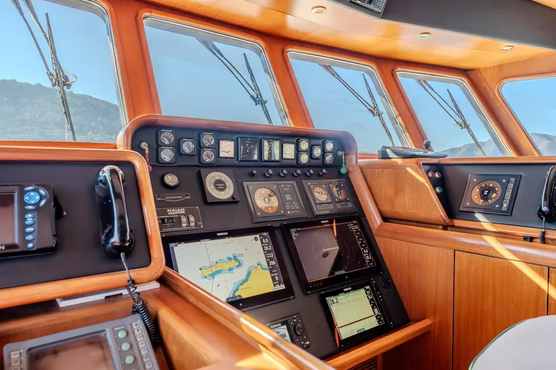 Yosma Yacht Photos Pics Luxurious 2013 Motor Yacht cockpit with advanced navigation systems and wooden interior.