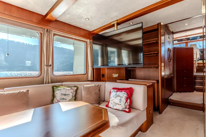 Yosma Yacht Photos Pics Luxurious 2013 Motor Yacht interior with plush seating, large TV, and elegant wood finishes.