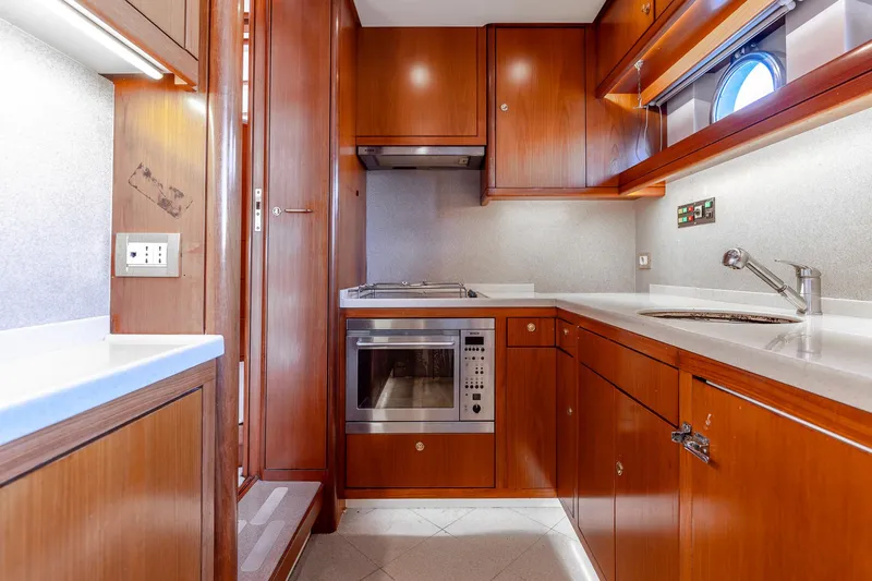 Yosma Yacht Photos Pics Luxurious 2013 Motor Yacht kitchen with wood cabinetry and modern appliances.