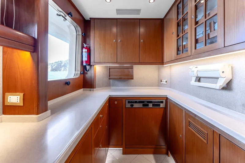 Yosma Yacht Photos Pics Luxurious 2013 Motor Yacht kitchen with wooden cabinets and modern appliances.