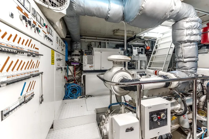 Yosma Yacht Photos Pics Engine room of a 2013 71' Motor Yacht, featuring control panels and machinery.