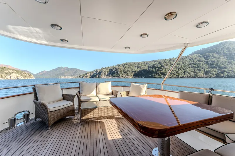 Yosma Yacht Photos Pics Luxurious 2013 Motor Yacht 71' deck with elegant seating and scenic ocean view.