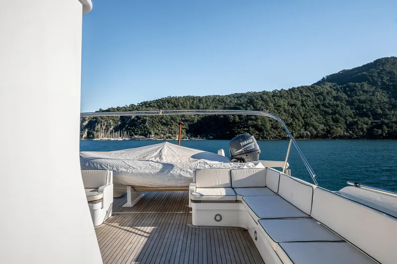 Yosma Yacht Photos Pics Luxurious 2013 Motor Yacht 71' deck with seating, overlooking serene waters and lush green hills.