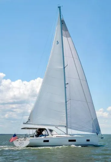 Circe Yacht Photos Pics 2022 Beneteau Oceanis Yacht 54 sailing on open water under clear blue skies.