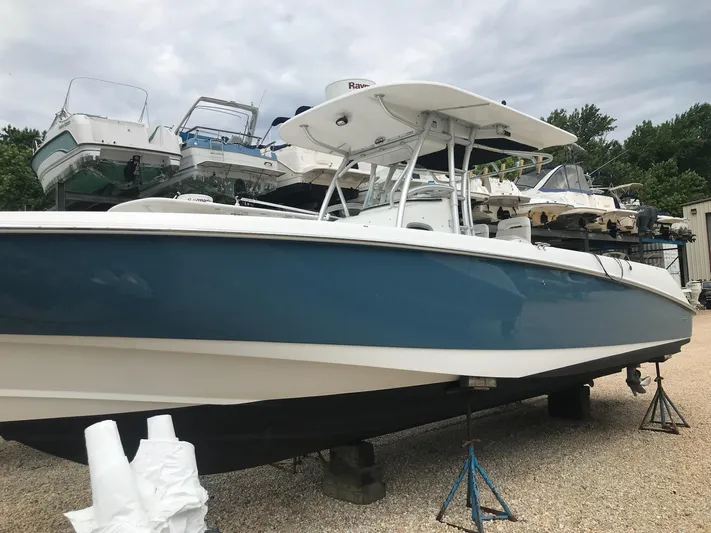  Yacht Photos Pics 2004 Boston Whaler 320 Outrage boat on stands, surrounded by other boats.