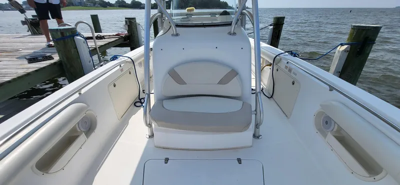  Yacht Photos Pics 2004 Boston Whaler 320 Outrage boat interior at dock, featuring seating and storage compartments.