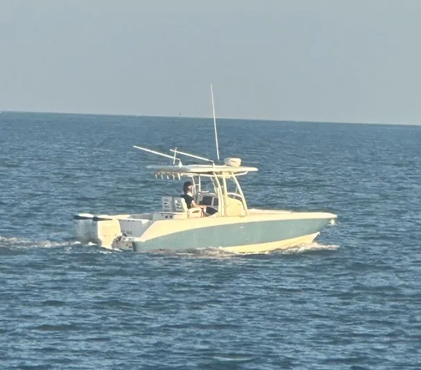  Yacht Photos Pics 2004 Boston Whaler 320 Outrage boat cruising on open water.