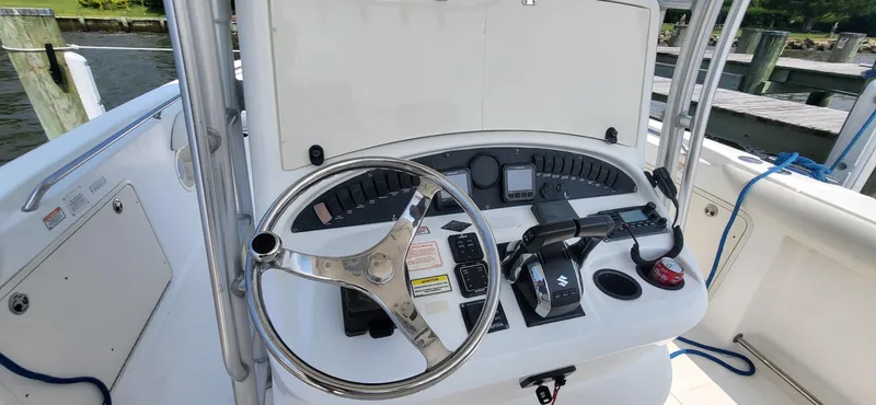  Yacht Photos Pics 2004 Boston Whaler 320 Outrage helm with steering wheel and control panel.