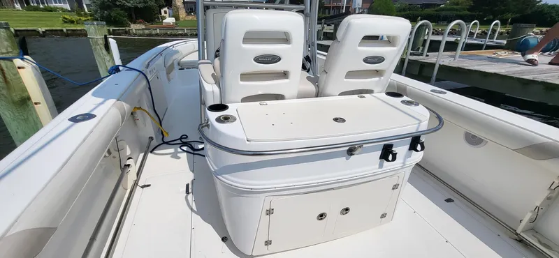  Yacht Photos Pics 2004 Boston Whaler 320 Outrage boat interior with seating and storage compartments.