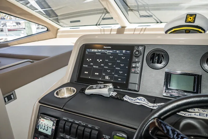 Yacht Photos Pics 2017 Sea Ray Sundancer 460 helm with navigation display and captain's hat.