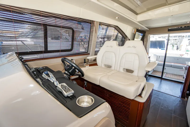  Yacht Photos Pics 2017 Sea Ray Sundancer 460 helm with plush seating and modern controls.