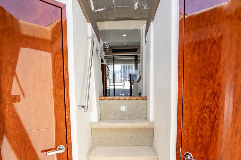  Yacht Photos Pics Interior view of 2017 Sea Ray Sundancer 460 yacht with polished wood doors and carpeted stairs.