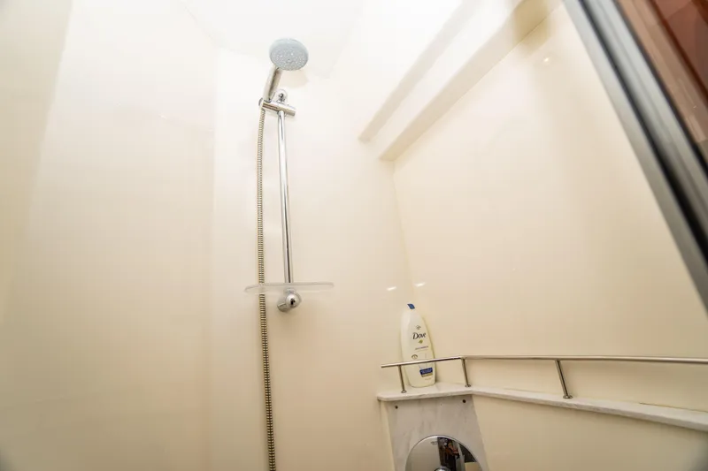  Yacht Photos Pics Shower area in 2017 Sea Ray Sundancer 460 yacht, featuring modern fixtures and Dove shampoo.