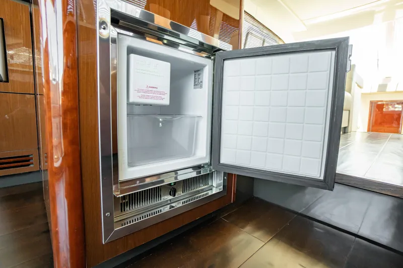  Yacht Photos Pics Open refrigerator inside 2017 Sea Ray Sundancer 460 yacht, showcasing modern interior design.