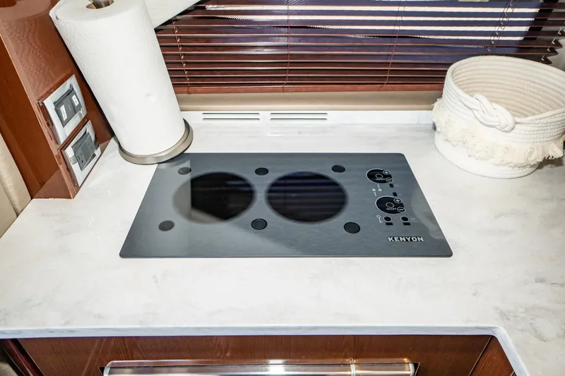  Yacht Photos Pics Kenyon cooktop in 2017 Sea Ray Sundancer 460 yacht kitchen, with paper towel and basket.