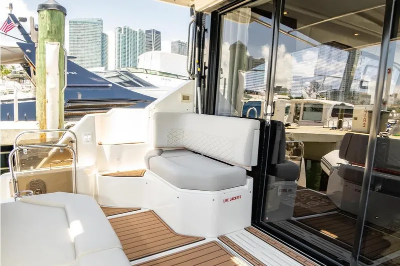  Yacht Photos Pics 2017 Sea Ray Sundancer 460 yacht interior with seating, docked in a marina.