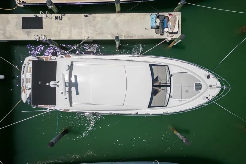  Yacht Photos Pics Overhead view of a 2017 Sea Ray Sundancer 460 yacht docked in green water.