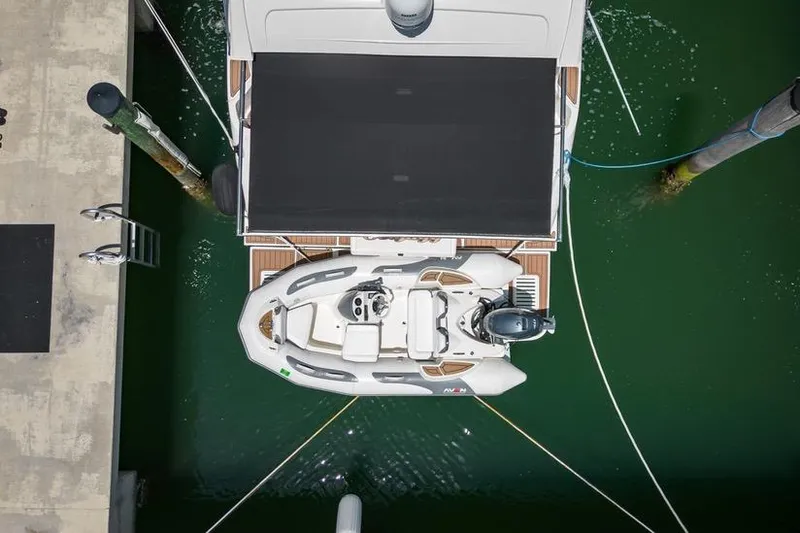  Yacht Photos Pics Overhead view of 2017 Sea Ray Sundancer 460 with a small boat docked.